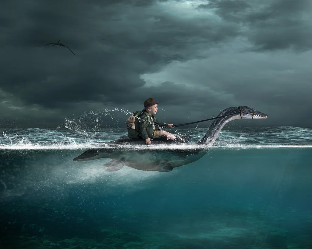 Boy in water riding a Plesiosaur