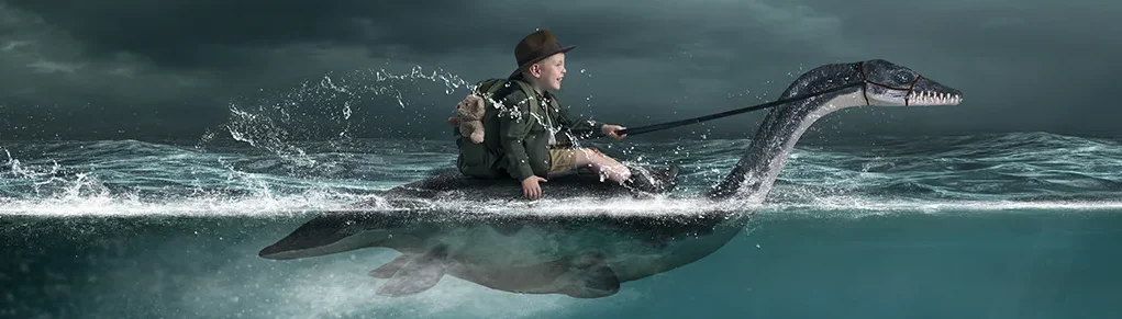 Boy in water riding a Plesiosaur