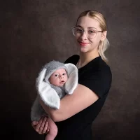 Mum holding her baby who is wearing a rabbit babbygro